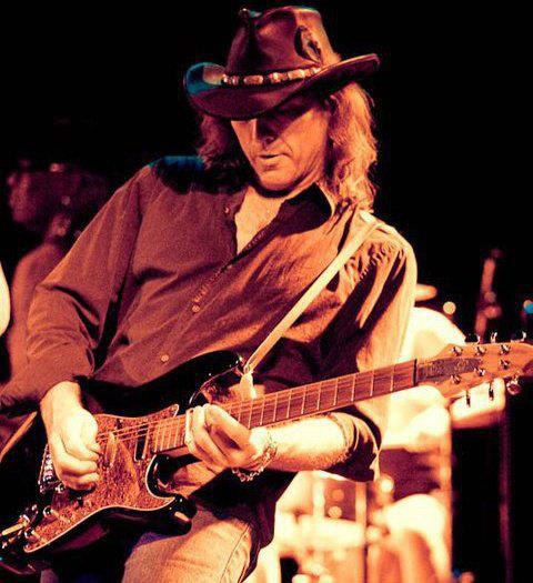 Don Victor T., a professional musician, playing banjo on stage